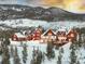 The exterior of a mountain home is lit up and backdropped by a vivid sunset at 300 Gold Hill Rd, Breckenridge, CO 80424