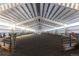 Spacious indoor horse riding arena with sand floor and white metal siding and roof at 300 Gold Hill Rd, Breckenridge, CO 80424