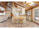 Open kitchen with a center island, ample counter space, and adjacent living area featuring beautiful beams at 300 Gold Hill Rd, Breckenridge, CO 80424