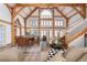Spacious living room featuring wooden beams, dining table, large windows, and comfortable seating area at 300 Gold Hill Rd, Breckenridge, CO 80424