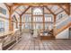 Grand living room with beautiful tile flooring, wooden beams, staircase, and high ceilings at 300 Gold Hill Rd, Breckenridge, CO 80424