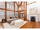Bright main bedroom features a decorative fireplace, hardwood floors and exposed wood beams at 300 Gold Hill Rd, Breckenridge, CO 80424