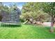 Spacious backyard with a trampoline, swing set, and playhouse for outdoor activities at 9669 E Prentice Cir, Greenwood Village, CO 80111
