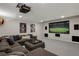 Finished basement featuring a large sectional sofa and entertainment center, perfect for movie nights at 9669 E Prentice Cir, Greenwood Village, CO 80111