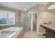 Bathroom showcasing a bathtub, glass-enclosed shower, and vanity with granite countertop at 9669 E Prentice Cir, Greenwood Village, CO 80111