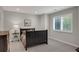Bedroom with a black bed frame, soft gray walls, and a large window at 9669 E Prentice Cir, Greenwood Village, CO 80111