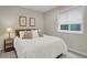 Comfortable bedroom with a plush bed, neutral tones, and natural light from the window at 9669 E Prentice Cir, Greenwood Village, CO 80111