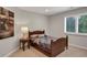 Bedroom with a wooden bed frame, natural light, and neutral decor for relaxation at 9669 E Prentice Cir, Greenwood Village, CO 80111
