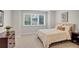 Cozy bedroom featuring a large window with shutters and a comfortable-looking bed at 9669 E Prentice Cir, Greenwood Village, CO 80111