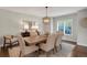Dining room featuring a modern chandelier, six upholstered chairs, and a light gray patterned rug at 9669 E Prentice Cir, Greenwood Village, CO 80111