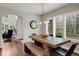 Dining room with a wooden table and chairs, large windows, and a modern light fixture at 9669 E Prentice Cir, Greenwood Village, CO 80111