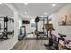 Home gym features modern exercise equipment, including weights, treadmill, and stationary bike at 9669 E Prentice Cir, Greenwood Village, CO 80111