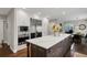 Stylish kitchen featuring white cabinets, stainless steel appliances, and an island with a white countertop at 9669 E Prentice Cir, Greenwood Village, CO 80111