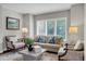 Bright living room featuring large windows with shutters, neutral decor, and hardwood floors at 9669 E Prentice Cir, Greenwood Village, CO 80111