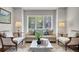 Bright living room featuring large windows with shutters, neutral decor, and hardwood floors at 9669 E Prentice Cir, Greenwood Village, CO 80111