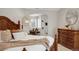 Main bedroom with wooden furniture, a cozy seating area, and a view of built-in shelving at 9669 E Prentice Cir, Greenwood Village, CO 80111