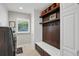 Charming mud room with built-in storage, bench, and convenient laundry area at 9669 E Prentice Cir, Greenwood Village, CO 80111