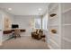 Home office featuring a built-in desk, comfortable chair, and ample natural light at 9669 E Prentice Cir, Greenwood Village, CO 80111