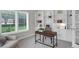 Bright home office with custom built-ins, a sleek desk, and serene backyard views from the window at 9669 E Prentice Cir, Greenwood Village, CO 80111
