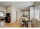 Bright dining area leading to the kitchen, featuring hardwood floors and a round wood table at 19810 County Road 1, Berthoud, CO 80513