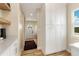 Hallway with ample storage cabinets, wooden floors, and a glimpse of the exterior at 19810 County Road 1, Berthoud, CO 80513