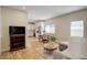 Open-concept living area with hardwood floors, dining table, kitchen, and comfortable seating at 19810 County Road 1, Berthoud, CO 80513