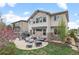 Expansive backyard featuring a stone patio with modern outdoor furniture and a well-maintained lawn at 24355 E Briarwood Ave, Aurora, CO 80016