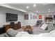 Finished basement with lounge area and workout equipment at 24355 E Briarwood Ave, Aurora, CO 80016