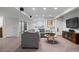 Spacious finished basement featuring a comfortable seating area, and neutral carpeting at 24355 E Briarwood Ave, Aurora, CO 80016