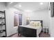 Basement bedroom with a black bed frame and egress window at 24355 E Briarwood Ave, Aurora, CO 80016
