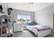 Bright bedroom with a window view, white furnishings, and decor at 24355 E Briarwood Ave, Aurora, CO 80016