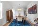 Bright dining room with modern decor features a pendant light fixture and stylish furnishings at 24355 E Briarwood Ave, Aurora, CO 80016