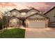 Inviting two-story home showcases stone accents, neutral siding, manicured lawn and an attached two car garage at 24355 E Briarwood Ave, Aurora, CO 80016