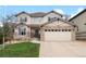 Inviting two-story home showcases stone accents, neutral siding, manicured lawn and an attached two car garage at 24355 E Briarwood Ave, Aurora, CO 80016