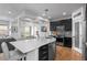 Stylish kitchen with dark cabinetry, stainless steel appliances, and a large center island with seating at 24355 E Briarwood Ave, Aurora, CO 80016