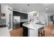 Bright, open kitchen with dark cabinets, stainless appliances and a large island perfect for entertaining at 24355 E Briarwood Ave, Aurora, CO 80016