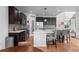Modern kitchen features dark cabinets, stainless steel appliances, and a center island with seating at 24355 E Briarwood Ave, Aurora, CO 80016