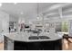 Contemporary kitchen featuring an island with a sink, opening into the living area with natural light at 24355 E Briarwood Ave, Aurora, CO 80016