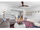Open-concept living room with hardwood floors, a neutral color scheme, and an adjacent stairway at 24355 E Briarwood Ave, Aurora, CO 80016