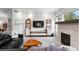 Comfortable living room with a fireplace, built-in shelving, and ample natural light from a large window at 24355 E Briarwood Ave, Aurora, CO 80016
