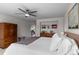 Spacious main bedroom with a ceiling fan, closet, and view of an additional living area at 24355 E Briarwood Ave, Aurora, CO 80016