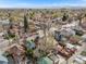 Scenic aerial shot of a residential area with a mix of homes, lush trees, and distant mountain views at 3361 W 29Th Ave, Denver, CO 80211