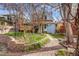 Picturesque backyard showcasing a lush garden, a deck, and a charming blue home at 3361 W 29Th Ave, Denver, CO 80211