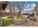 Manicured backyard features an outdoor lounge, garden beds, a greenhouse, and artifical turf at 3361 W 29Th Ave, Denver, CO 80211