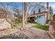 Charming backyard featuring a lush garden, patio area, and a beautiful blue two-story home at 3361 W 29Th Ave, Denver, CO 80211