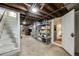 Unfinished basement with exposed ceiling and shelving unit at 3361 W 29Th Ave, Denver, CO 80211