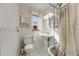 Bathroom with pedestal sink, wainscoting, and shower with curtain at 3361 W 29Th Ave, Denver, CO 80211