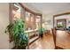 Sunlit dining area features hardwood floors, a large bay window, and views of the neighborhood at 3361 W 29Th Ave, Denver, CO 80211