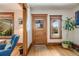 Inviting entryway featuring hardwood floors, a wooden front door with glass, and natural light from a side window at 3361 W 29Th Ave, Denver, CO 80211