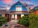 Charming two-story home with a blue and red brick exterior, a covered porch, and well-maintained landscaping at 3361 W 29Th Ave, Denver, CO 80211
